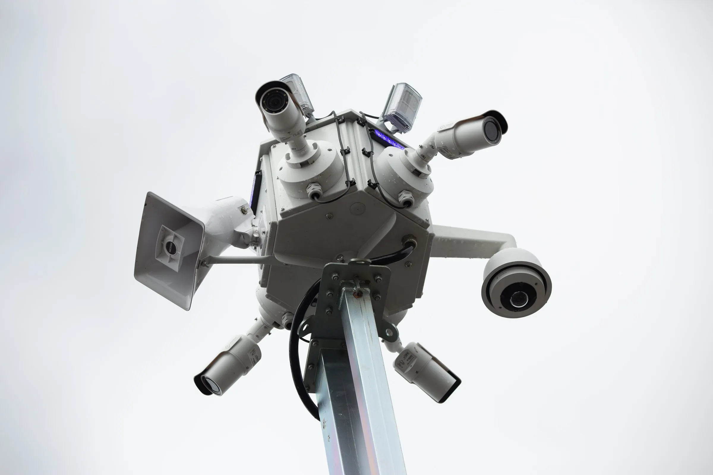 Low-angle view of an Odin Systems camera mast against the sky